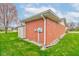The exterior of this brick home has nice landscaping and a convenient storage shed at 1503 Saint John S Ct, Beech Grove, IN 46107