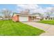 A single-story home with brick accents and a well-maintained lawn, showcasing its inviting curb appeal at 1503 Saint John S Ct, Beech Grove, IN 46107