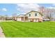 Inviting two-story home featuring a combination of brick and siding, complemented by a lush green lawn at 1503 Saint John S Ct, Beech Grove, IN 46107