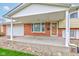 Covered front porch with brick accents, offering a welcoming entrance to the home at 1503 Saint John S Ct, Beech Grove, IN 46107