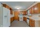 Spacious kitchen with wood cabinets, white appliances, and plenty of counter space at 1503 Saint John S Ct, Beech Grove, IN 46107