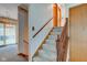 Carpeted staircase with wooden banister leading to upper level with natural light streaming through windows at 1503 Saint John S Ct, Beech Grove, IN 46107