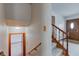 Bright stairwell leading to the main level with a glimpse of the front entry door at 1503 Saint John S Ct, Beech Grove, IN 46107