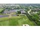 Aerial shot of the clubhouse, golf course, and tennis courts in a lush, green setting at 15150 Mooring E Cir, Carmel, IN 46033