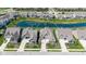 Aerial view of the home surrounded by lush landscaping and a tranquil pond at 15150 Mooring E Cir, Carmel, IN 46033