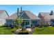 Aerial view of backyard featuring patio with table set and manicured landscaping at 15150 Mooring E Cir, Carmel, IN 46033