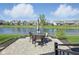 Backyard patio featuring outdoor dining set with pond view at 15150 Mooring E Cir, Carmel, IN 46033