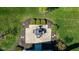 Aerial view of a manicured backyard showcasing a stone patio with an outdoor dining set at 15150 Mooring E Cir, Carmel, IN 46033