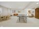 Spacious carpeted basement with dining table, ping pong table, arm chair and wooden armoire at 15150 Mooring E Cir, Carmel, IN 46033