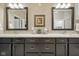 Bathroom vanity with granite counters, dual sinks, framed mirrors, and dark cabinets at 15150 Mooring E Cir, Carmel, IN 46033