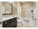 Bathroom with shower-tub combo, single sink vanity, and neutral tile at 15150 Mooring E Cir, Carmel, IN 46033