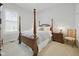 Bedroom featuring a four-poster bed with neutral bedding and a side table with lamp at 15150 Mooring E Cir, Carmel, IN 46033