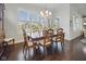 Elegant dining room with a chandelier, shutters, and a view of the outdoors at 15150 Mooring E Cir, Carmel, IN 46033