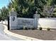Community entrance featuring a brick and stone sign, framed by well-maintained landscaping at 15150 Mooring E Cir, Carmel, IN 46033