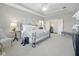 Spacious main bedroom with a tray ceiling, ensuite access, and a cozy sitting area at 15150 Mooring E Cir, Carmel, IN 46033
