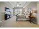 Serene primary bedroom with a tray ceiling, sitting area, and plenty of natural light at 15150 Mooring E Cir, Carmel, IN 46033