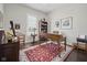 A well-lit office featuring an antique desk, a patterned rug, and ample shelving at 15150 Mooring E Cir, Carmel, IN 46033