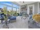 Comfortable sunroom with brick fireplace and windows offering panoramic views of the lake at 15150 Mooring E Cir, Carmel, IN 46033