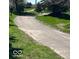 Scenic community walking path through grassy areas, perfect for an afternoon stroll at 15150 Mooring E Cir, Carmel, IN 46033