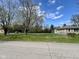 View of the house with a chain link fence, manicured yard, and street view at 1710 Stevenson St, Indianapolis, IN 46228