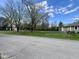 View of the house with a chain link fence, manicured yard, and street view at 1710 Stevenson St, Indianapolis, IN 46228