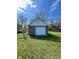 View of the detached one car garage with a white door in the backyard at 1710 Stevenson St, Indianapolis, IN 46228