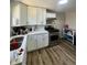 Updated kitchen features white cabinetry, stainless steel appliances and new laminate flooring at 1710 Stevenson St, Indianapolis, IN 46228