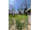 Expansive grassy yard surrounded by mature trees offers a private and serene outdoor space at 1710 Stevenson St, Indianapolis, IN 46228