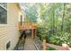 Side view of a home with a wooden deck overlooking a gravel path and wooded area, providing privacy and outdoor space at 1770 Valleywood Dr, Avon, IN 46123