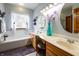 Well-lit bathroom featuring a soaking tub, double vanity, and decorative accents for a relaxing atmosphere at 1770 Valleywood Dr, Avon, IN 46123