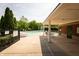 Community pool area with sun loungers, tables, and a covered pavilion, perfect for relaxation and social gatherings at 1770 Valleywood Dr, Avon, IN 46123