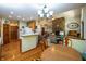 View of dining area and living room with a brick fireplace and hardwood floors and a breakfast bar at 1770 Valleywood Dr, Avon, IN 46123