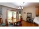 Eat-in kitchen features hardwood floors and a dining table next to an access door to the outside deck at 1770 Valleywood Dr, Avon, IN 46123