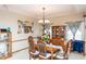Formal dining room featuring wooden table set, ornate mirror, and classic chandelier at 1770 Valleywood Dr, Avon, IN 46123