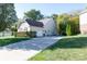 Side view of home with neutral siding, long driveway, and attached garage at 1770 Valleywood Dr, Avon, IN 46123