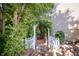 Charming garden entrance featuring a white picket fence, stone path, and a greenery-covered archway leading to wooden stairs at 1770 Valleywood Dr, Avon, IN 46123
