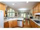Bright kitchen overlooks the dining area with hardwood floors, and the living room with arched windows at 1770 Valleywood Dr, Avon, IN 46123