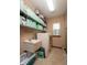 Functional laundry room with ample shelving, a utility sink, and a washing machine for added convenience at 1770 Valleywood Dr, Avon, IN 46123