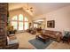 Spacious living room boasts a vaulted ceiling, fireplace, and lots of natural light from the arched windows at 1770 Valleywood Dr, Avon, IN 46123