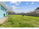 Large, grassy backyard with fencing around the perimeter at 1857 Calvin St, Indianapolis, IN 46203
