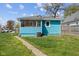 Back of house with grass lawn, air conditioner and porch at 1857 Calvin St, Indianapolis, IN 46203