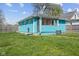 Backyard with grass, fence, and light-blue painted house at 1857 Calvin St, Indianapolis, IN 46203