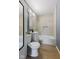 Modern bathroom with tile floor, white vanity, and tub at 1857 Calvin St, Indianapolis, IN 46203