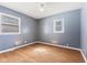 Bright bedroom featuring wood flooring, modern paint, and large windows offering natural light at 1857 Calvin St, Indianapolis, IN 46203