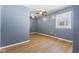 Bedroom with wood floors, ceiling fans, and a window at 1857 Calvin St, Indianapolis, IN 46203