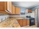 Kitchen featuring wooden cabinets, double sinks, and modern stainless-steel appliances at 1857 Calvin St, Indianapolis, IN 46203