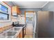 A kitchen featuring wood cabinets, tile backsplash, stainless-steel appliances, and wood flooring at 1857 Calvin St, Indianapolis, IN 46203