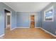 Bright living room featuring wood flooring, modern paint, and an opening leading to other rooms at 1857 Calvin St, Indianapolis, IN 46203