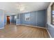 Open living room featuring wood flooring, modern paint, and an opening leading to the kitchen at 1857 Calvin St, Indianapolis, IN 46203