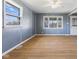 Bright living room featuring wood flooring, modern paint, and large windows offering natural light at 1857 Calvin St, Indianapolis, IN 46203
